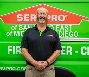 SERVPRO employee standing in front of truck