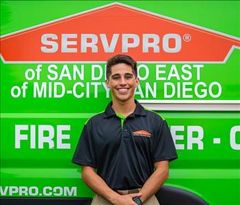 Man standing in front of a green SERVPRO background.