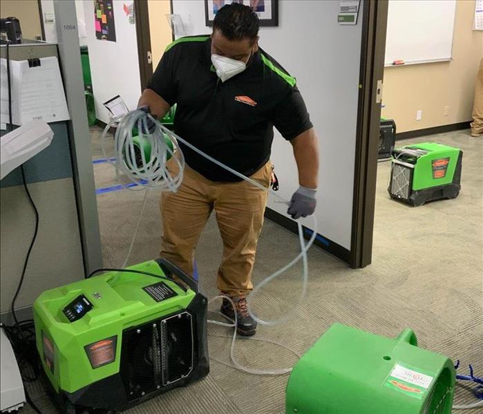 Team member setting up drying equipment.