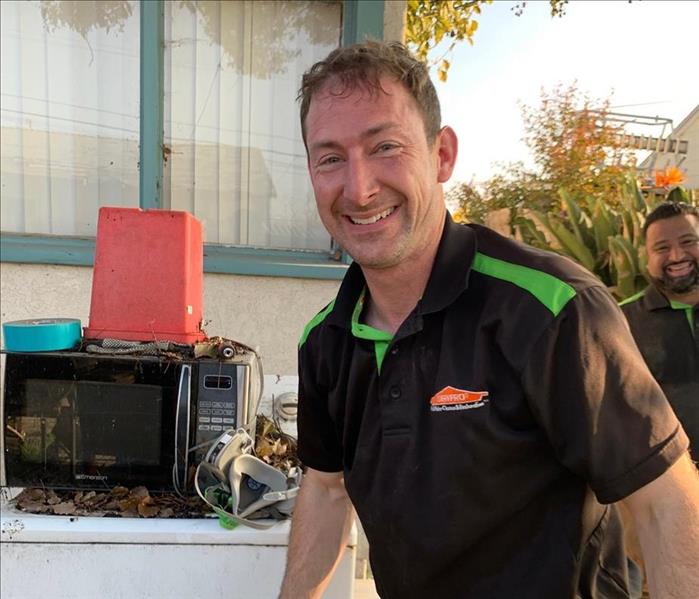 male production manager smiling after a muck out job