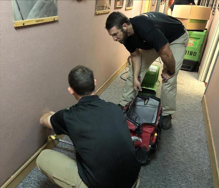 Two of our SERVPRO employees taking moisture readings.