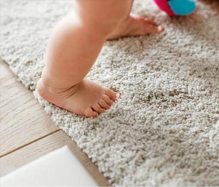 baby stepping on carpet