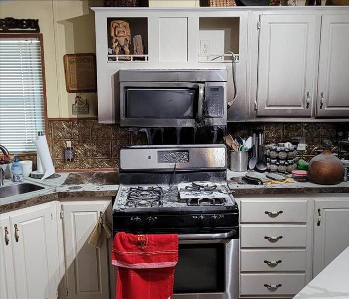 A kitchen with fire damage.