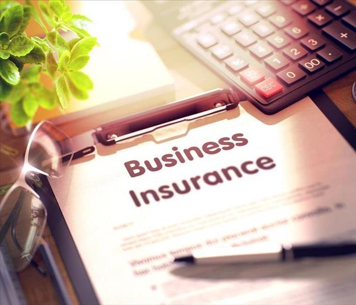 Business Insurance. Composition with Clipboard, Calculator, Glasses, Green Flower and Office Supplies on Desk