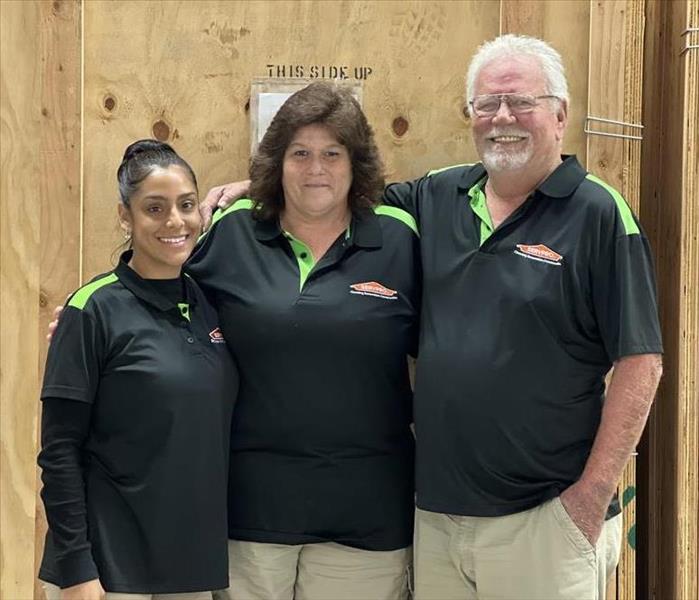 Three employees smiling.