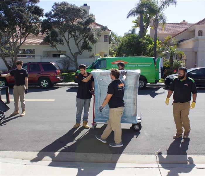 SERVPRO of San Diego East crew lifting heavy furniture