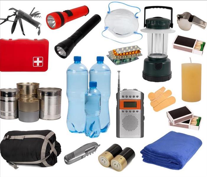 Flashlight, portable radio, batteries, water bottles and a first aid kit